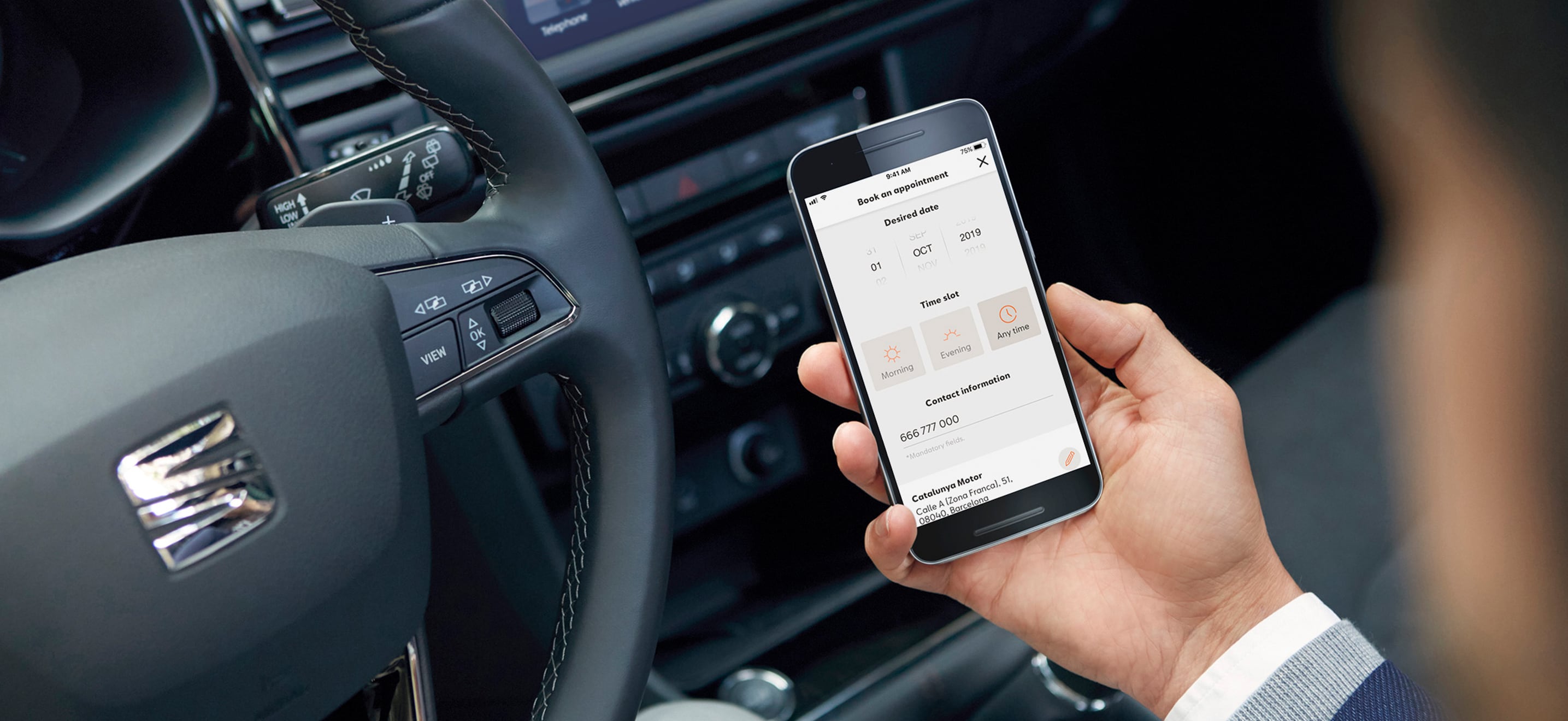 SEAT new car services and maintenance – My SEAT App in action in a car driver holding a phone