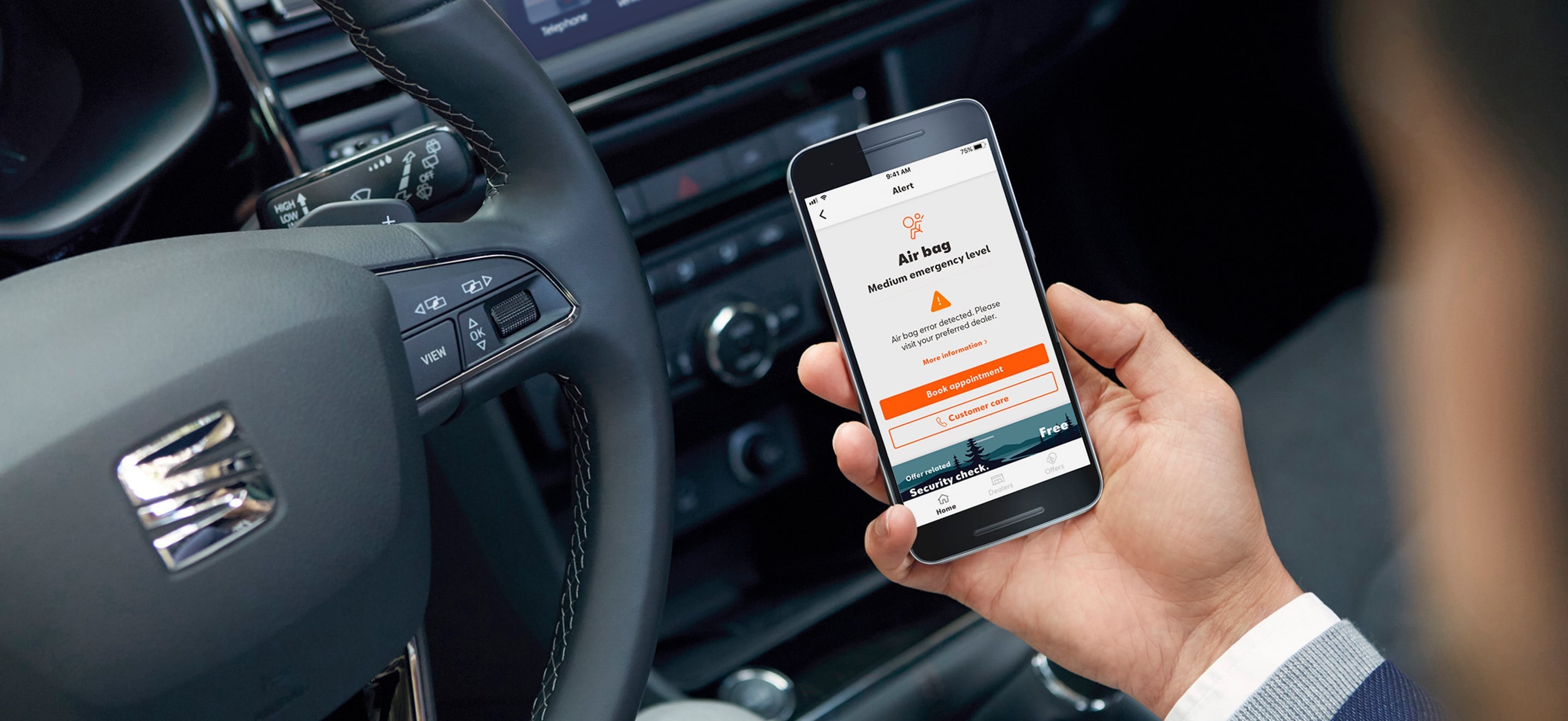 SEAT new car services and maintenance – My SEAT App in action in a car driver holding a phone